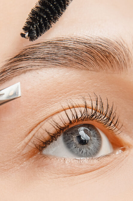 Master tweezers depilation of eyebrow hair in women, brow correction